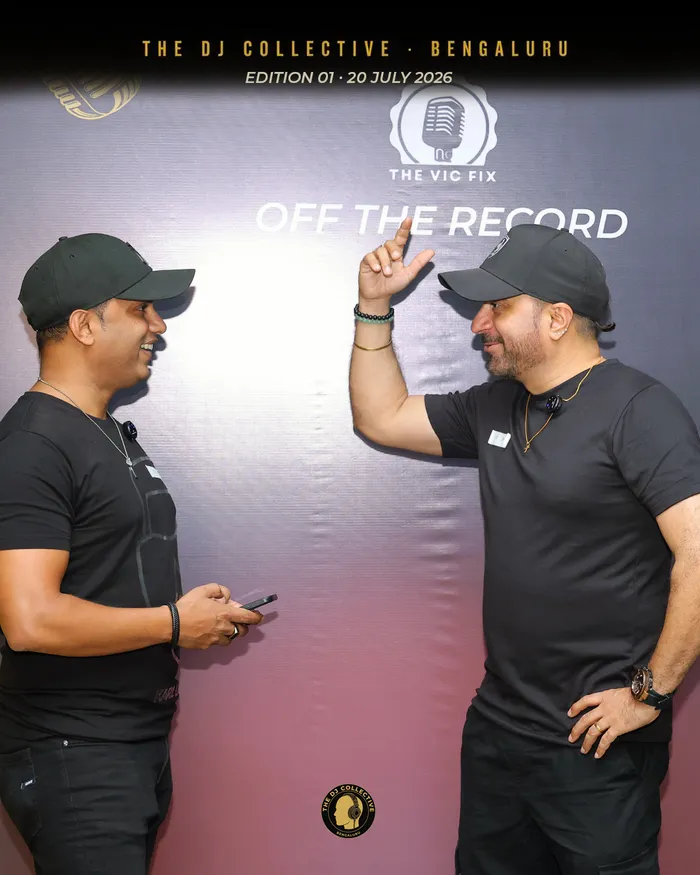 Two DJs talking, one gesturing to make a point