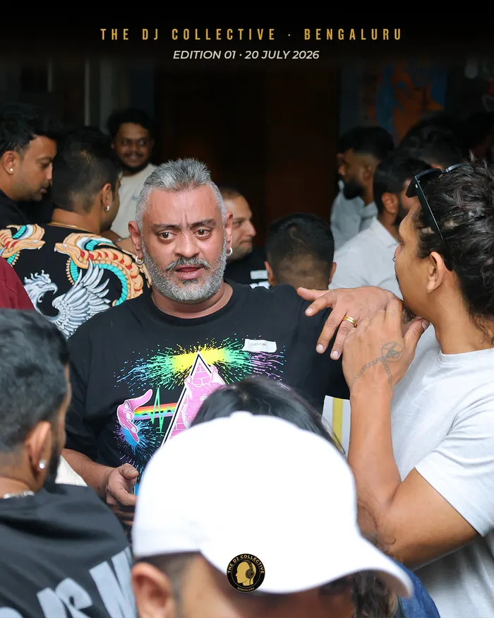A DJ working the room, greeting people as he moves through