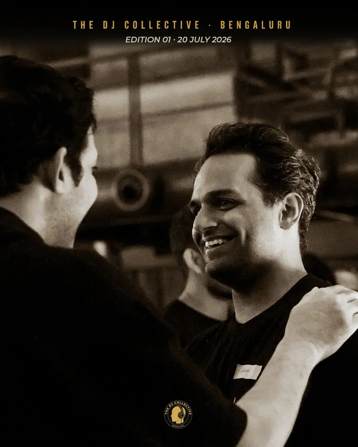 Two DJs in conversation, one laughing